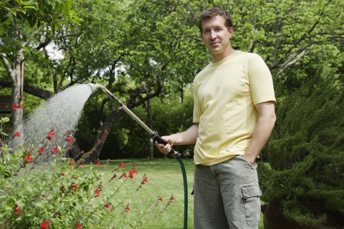 Gardener working in a Peckham garden with tools